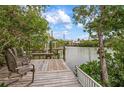 Relaxing wooden deck overlooking the calm waters, ideal for enjoying the view at 727 Holly Rd, Anna Maria, FL 34216