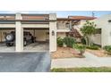 Spanish style condo building with attached garage and lush landscaping at 764 Avenida Estancia # 208, Venice, FL 34292