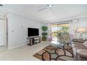 Living room with leather furniture and tiled floors at 764 Avenida Estancia # 208, Venice, FL 34292