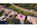 Bird's-eye view of a house with a tile roof and a lush green lawn at 8282 Parkside Dr, Englewood, FL 34224