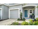 Townhome entrance with teal door, landscaping, and attached garage at 8533 Lunar Skye St, Sarasota, FL 34241