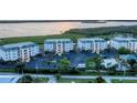 Aerial view of waterfront community with building and parking at 9203 Griggs Rd # B304, Englewood, FL 34224