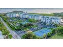 Aerial view of community, tennis court, and waterfront at 9203 Griggs Rd # B304, Englewood, FL 34224