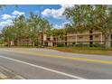 Condo building exterior showcasing street and landscaping at 104 Capri Isles Blvd # 112, Venice, FL 34292