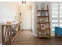 Bright and airy entryway with decorative shelving and console table at 1110 2Nd S Ave, Tierra Verde, FL 33715