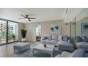 Bright living room with comfy seating and access to a balcony at 1111 N Gulfstream Ave # 3E, Sarasota, FL 34236