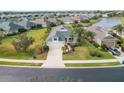 House nestled in a neighborhood with a pond nearby at 12240 Whisper Lake Dr, Bradenton, FL 34211