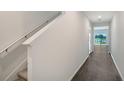 Bright entryway with stairs, dark flooring, and view to living area at 13115 Cedar Elm Lane, Parrish, FL 34219