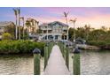 Private dock leading to a luxury waterfront home at 144 N Casey Key Rd, Osprey, FL 34229