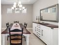Bright dining room featuring a farmhouse table and white buffet at 16127 Fortezza Dr, Bradenton, FL 34211