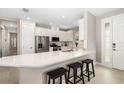 Modern kitchen with white cabinets, stainless steel appliances, and an island at 16127 Fortezza Dr, Bradenton, FL 34211
