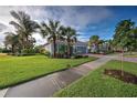 Landscaped yard with tropical plants and a view of a single-story home at 19451 Quisto St, Venice, FL 34293