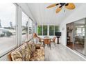 Relaxing screened porch with wicker furniture and glass-top table at 2107 Palma Sola Blvd # 59, Bradenton, FL 34209