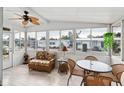 Bright screened porch with wicker furniture and view of the community at 2107 Palma Sola Blvd # 59, Bradenton, FL 34209