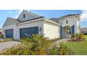 Front view of a charming two-story house with a two-car garage at 21628 Lake Placid Way, Venice, FL 34293