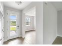 Bright entryway with tile flooring and view into an adjacent room at 3425 Dryden St, North Port, FL 34288