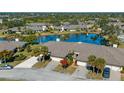 Aerial view of a home overlooking a serene pond in a well-maintained community at 3663 Muirfield Dr # 4B, Sarasota, FL 34238