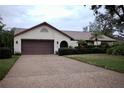 Single-story house with brown garage door and well-kept lawn at 3947 Country View Dr, Sarasota, FL 34233