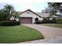 Single-story house with brown garage door and manicured lawn at 3947 Country View Dr, Sarasota, FL 34233