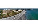 Beachfront property showcasing a multi-unit building and pristine beach at 415 L Ambiance Dr # C204, Longboat Key, FL 34228