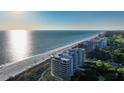 Aerial view of beachfront high-rise condos with expansive ocean views at 415 L Ambiance Dr # C204, Longboat Key, FL 34228