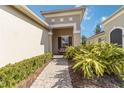 Brick walkway to home entrance with manicured hedges at 5050 Maymont Park, Bradenton, FL 34203