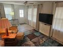 Living room featuring a large TV and comfy seating at 5619 Bayshore Rd # 115, Palmetto, FL 34221