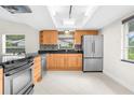 Modern kitchen with stainless steel appliances and wood cabinets at 5916 Bonaventure Pl, Sarasota, FL 34243