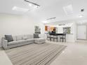 Bright living room featuring a sectional sofa and large rug at 5916 Bonaventure Pl, Sarasota, FL 34243