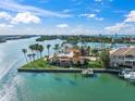 Aerial view of waterfront home on private island with boat dock and tropical landscaping at 929 Casey Cove Dr, Nokomis, FL 34275