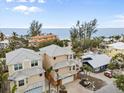Beachfront property view with a tan house and ocean at 107 75Th St, Holmes Beach, FL 34217