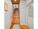 Wooden staircase with a light-colored wood railing at 107 75Th St, Holmes Beach, FL 34217