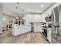 Modern kitchen with white cabinets, stainless steel appliances, and quartz countertops at 1463 Jinright Rd, North Port, FL 34288