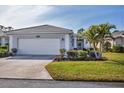 House exterior showcasing a garage and well-manicured lawn at 1570 Monarch Dr, Venice, FL 34293