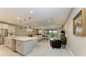 Open-concept kitchen with island, stainless steel appliances, and white cabinets at 17120 Cresswind Ter, Bradenton, FL 34211