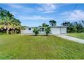 Newly renovated single story home with a carport and beautifully landscaped lawn at 2726 Jerry Ave, Punta Gorda, FL 33950