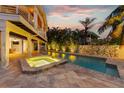Stunning pool and spa, surrounded by lush landscaping at 315 Hammock Cir, Anna Maria, FL 34216