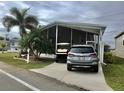 Mobile home with carport, golf cart, and landscaping at 322 Blackburn Blvd, North Port, FL 34287