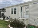 Front entrance with stairs and landscaping at 322 Blackburn Blvd, North Port, FL 34287