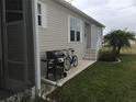 Side yard with grill, bicycle, and landscaping at 322 Blackburn Blvd, North Port, FL 34287
