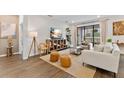 Spacious living room with light colored couch and large TV at 3409 Anchor Bay Trl, Lakewood Ranch, FL 34211