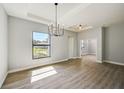 Bright dining room featuring a chandelier and large window at 3850 Skyway Ave, North Port, FL 34288