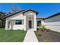 Front view of a house with walkway leading to the front door at 3850 Skyway Ave, North Port, FL 34288