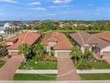 Aerial view of a single Gathering home with a two-car garage and lush landscaping at 3904 Waypoint Ave, Osprey, FL 34229