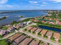 Wide aerial view of waterfront community with single Gathering home highlighted at 3904 Waypoint Ave, Osprey, FL 34229