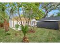 View of backyard with shed, pergola, and lush landscaping at 4536 1St N Ave, St Petersburg, FL 33713