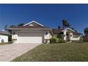 House exterior view, featuring a white double garage door and manicured lawn at 5107 86Th Street W Ct, Bradenton, FL 34210