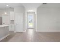 Bright and airy entryway with tile flooring and neutral color palette at 5587 Farmington Ave, North Port, FL 34288