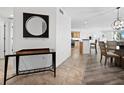 Open concept entryway with glass-top console table and view into dining area at 650 Golden Gate Pt # 401, Sarasota, FL 34236