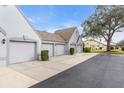 Three-car garage with individual doors and landscaping at 6807 Stone River Rd # 204, Bradenton, FL 34203